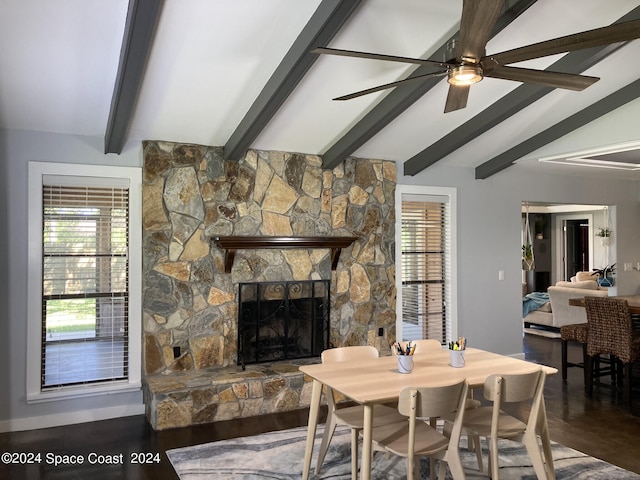 living room with a wealth of natural light, ceiling fan, hardwood / wood-style floors, and a stone fireplace