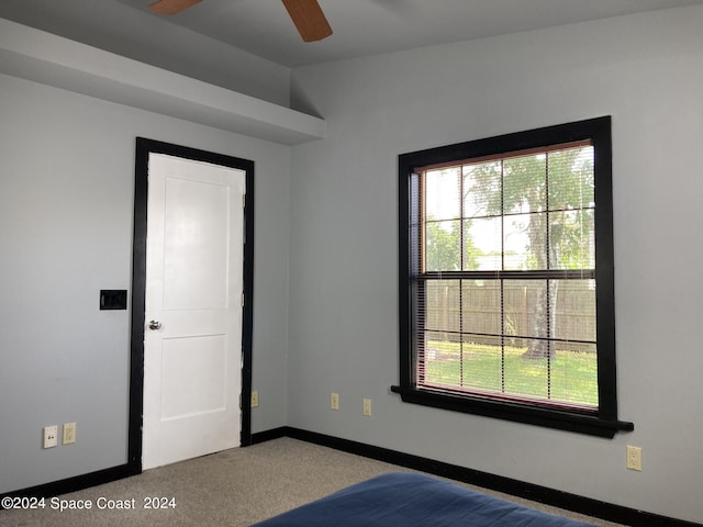 unfurnished bedroom with ceiling fan and carpet