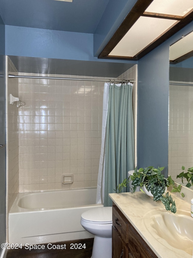 full bathroom with shower / bath combination with curtain, vanity, and toilet