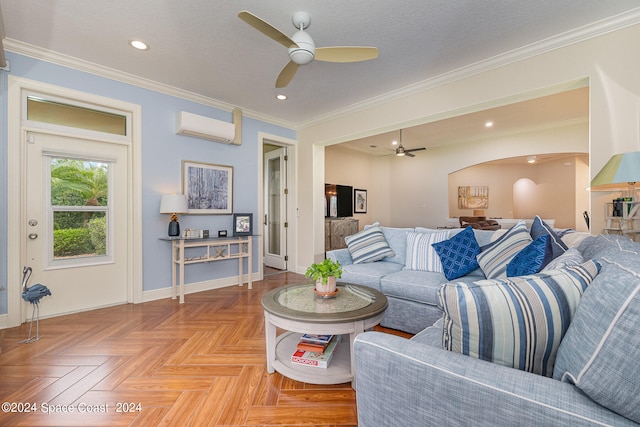 living room with a textured ceiling, a wall mounted air conditioner, ornamental molding, ceiling fan, and light parquet floors