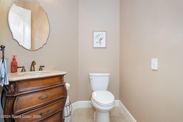 bathroom featuring vanity, toilet, and tile patterned floors