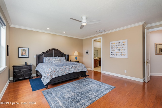 bedroom featuring wood-type flooring, ceiling fan, ensuite bathroom, and crown molding