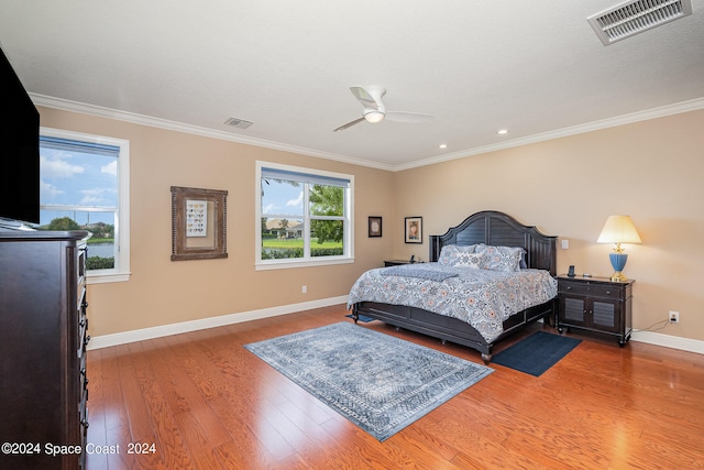 bedroom with wood-type flooring, ceiling fan, and crown molding