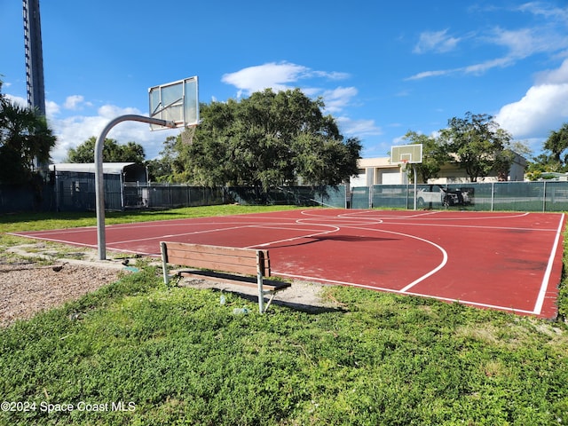 view of sport court with a lawn