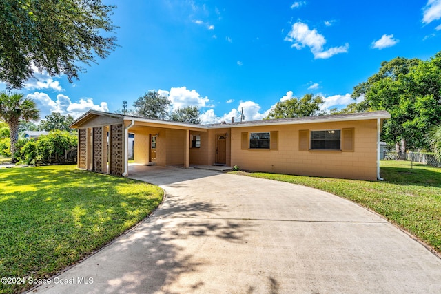 2415 Stanford Dr, Cocoa, FL 32926 - view of front of property featuring driveway, concrete block siding, and a carport