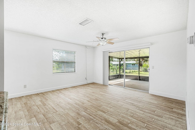 2415 Stanford Dr, Cocoa, FL 32926 - spare room featuring a ceiling fan, wood finished floors, a textured ceiling, and baseboards