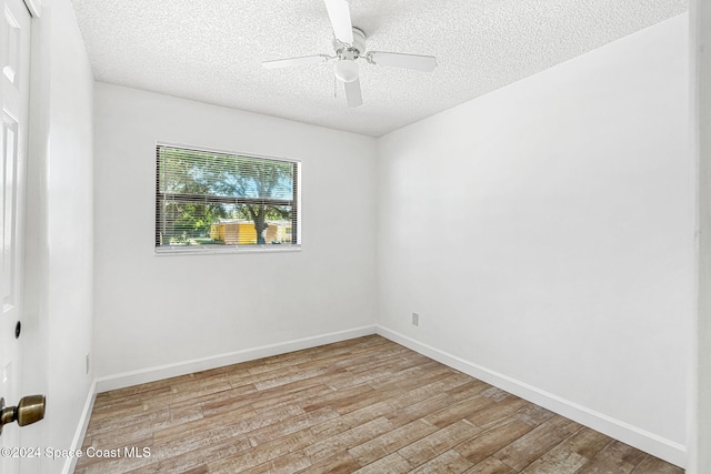 2415 Stanford Dr, Cocoa, FL 32926 - unfurnished room featuring a textured ceiling, light wood finished floors, baseboards, and ceiling fan