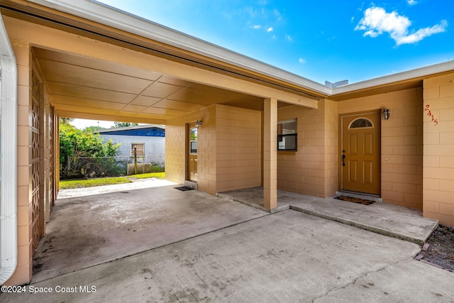 2415 Stanford Dr, Cocoa, FL 32926 - property entrance featuring concrete block siding and an attached carport