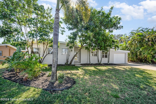 view of front facade with a garage and a front lawn