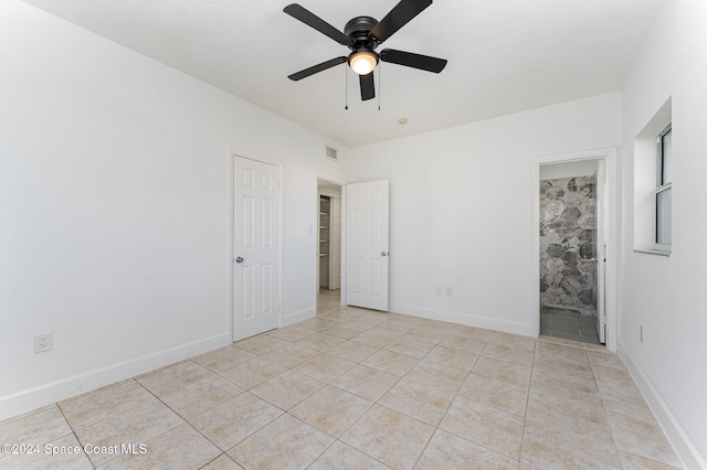 tiled empty room with ceiling fan