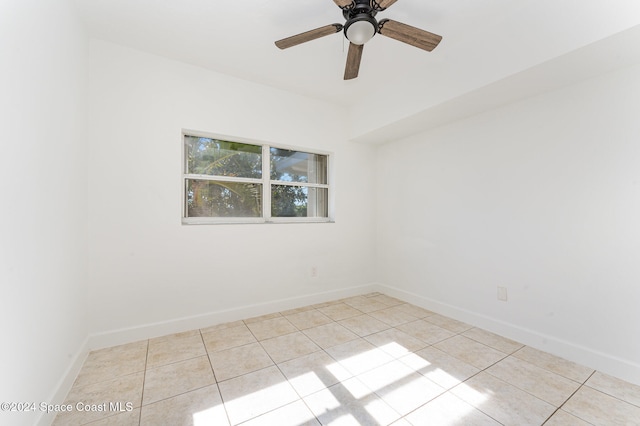 tiled spare room with ceiling fan