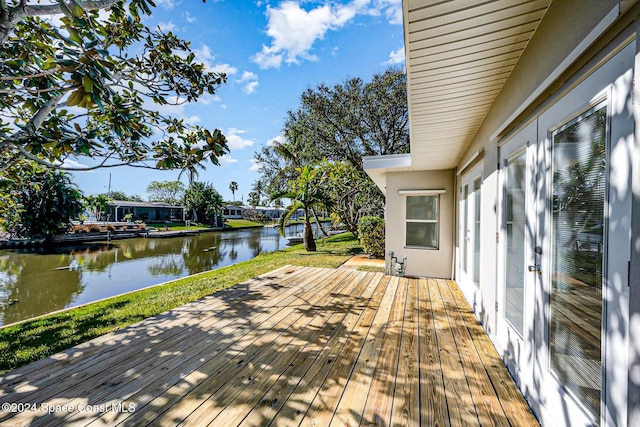 wooden terrace featuring a water view