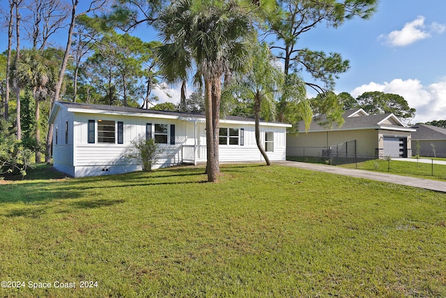 single story home featuring a garage and a front yard