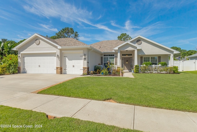 view of front of property with a garage, a porch, and a front lawn