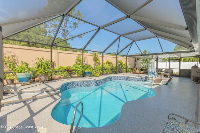 view of swimming pool with pool water feature, a patio, and glass enclosure