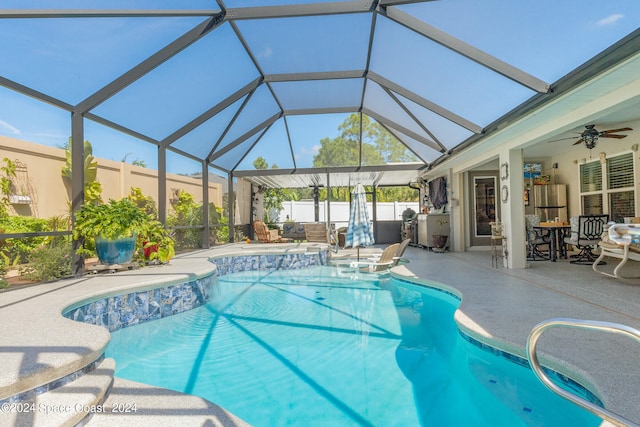 view of swimming pool with a lanai, a patio, and ceiling fan