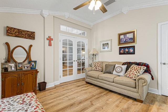 living room with ceiling fan, light hardwood / wood-style floors, french doors, crown molding, and vaulted ceiling