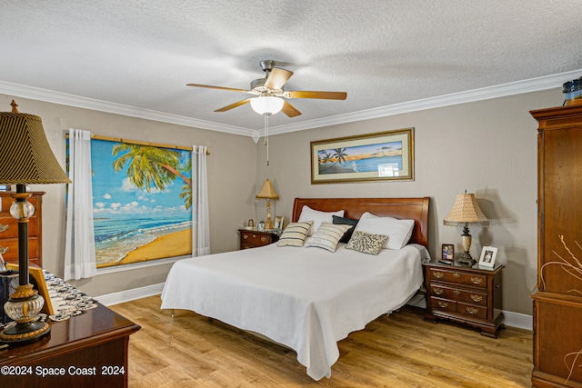 bedroom featuring a textured ceiling, light hardwood / wood-style floors, ornamental molding, and ceiling fan