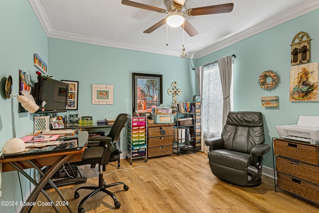 office space featuring light wood-type flooring, a textured ceiling, ceiling fan, and crown molding