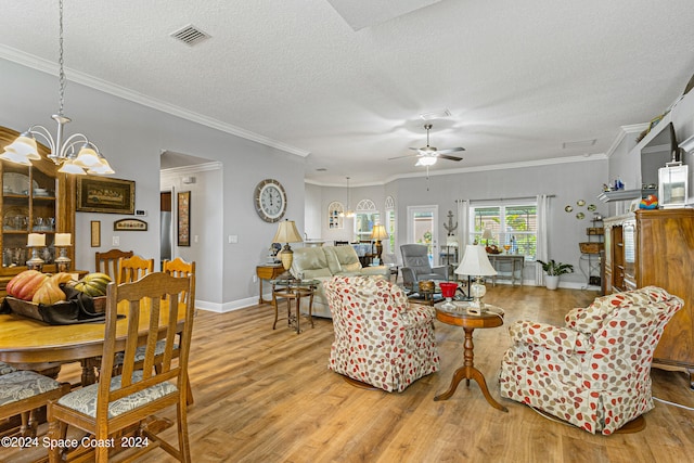 living room featuring a textured ceiling, crown molding, ceiling fan with notable chandelier, and hardwood / wood-style floors