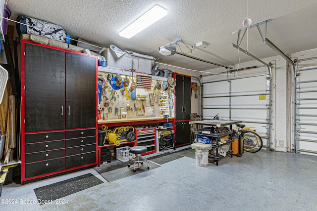 garage featuring a garage door opener and a workshop area