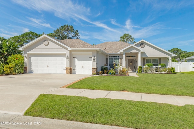 single story home with a garage and a front lawn