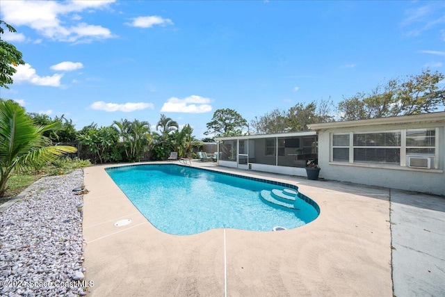 view of pool featuring a patio and a sunroom