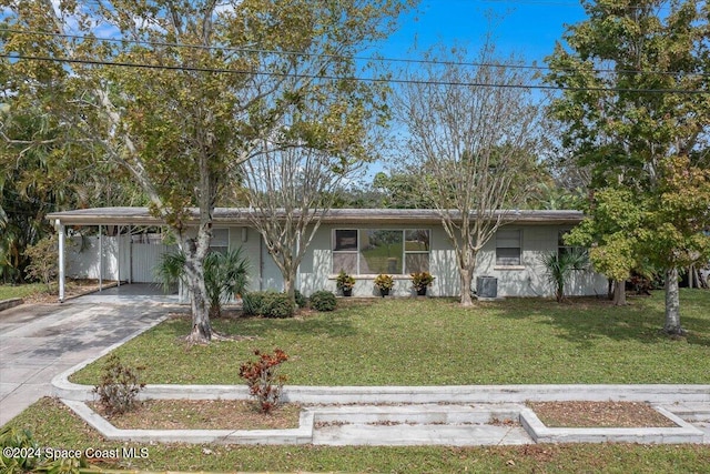 single story home featuring a carport, a front yard, and central AC