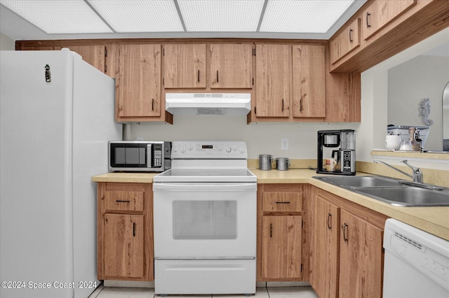 kitchen featuring white appliances and sink