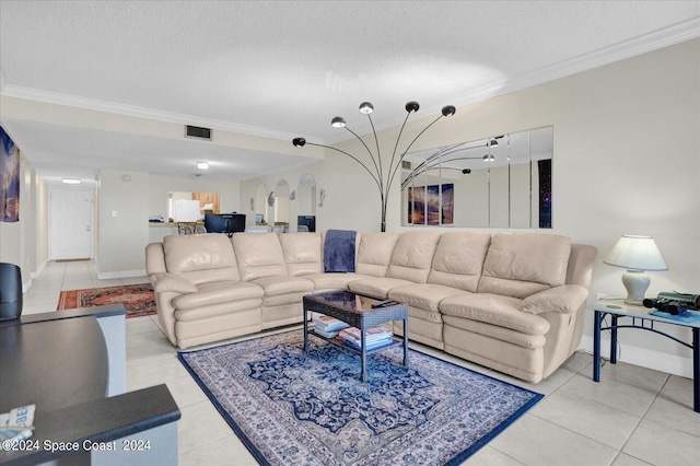 living room featuring a textured ceiling, crown molding, and light tile patterned floors