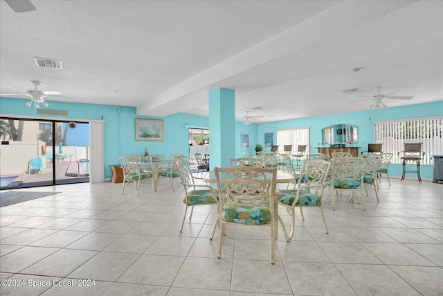 unfurnished dining area featuring ceiling fan and plenty of natural light