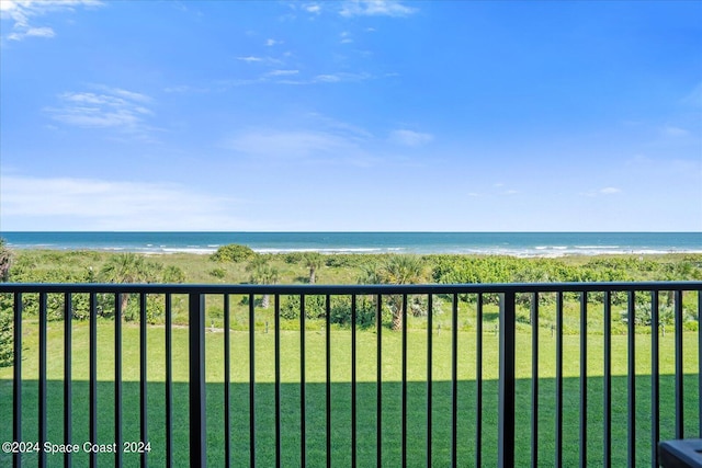 balcony featuring a view of the beach and a water view