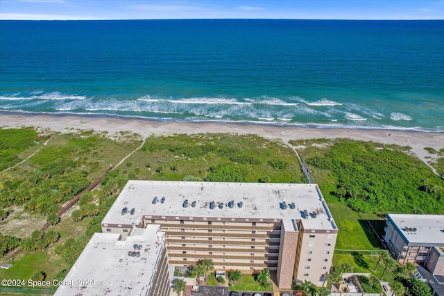 aerial view with a water view and a beach view