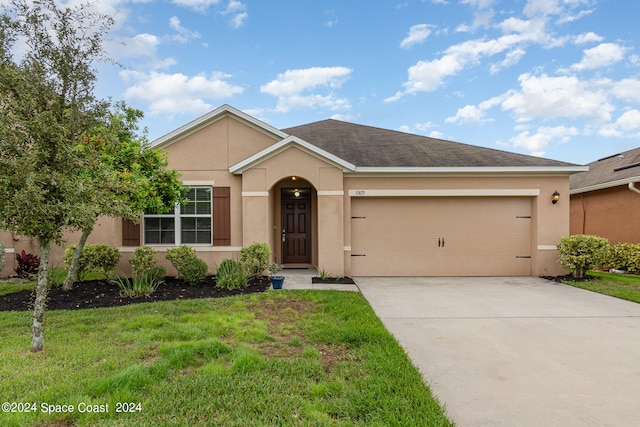 single story home featuring a front yard and a garage