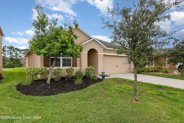 view of front of house with a front yard and a garage