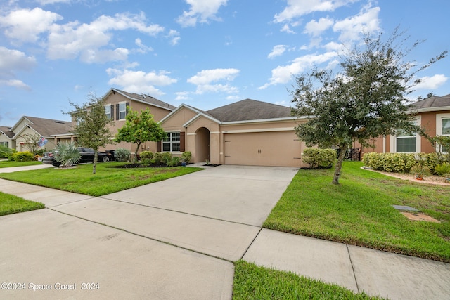 view of front of property featuring a garage and a front lawn