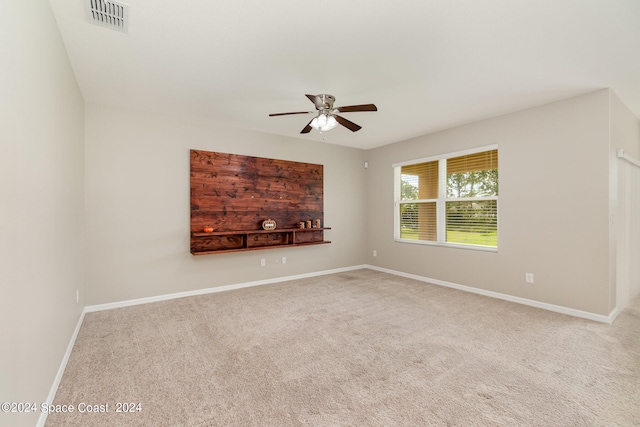 unfurnished living room featuring carpet floors and ceiling fan