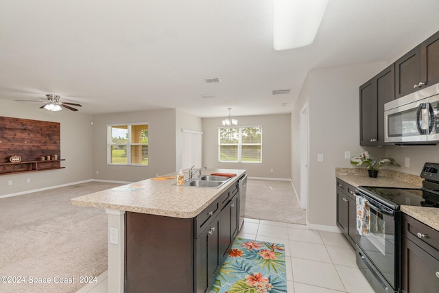 kitchen with appliances with stainless steel finishes, sink, ceiling fan with notable chandelier, and plenty of natural light