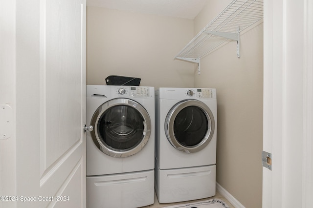 clothes washing area featuring washing machine and clothes dryer