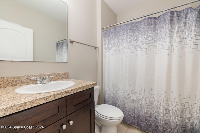 bathroom featuring walk in shower, vanity, toilet, and tile patterned flooring