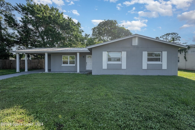 ranch-style home with a front yard and a carport