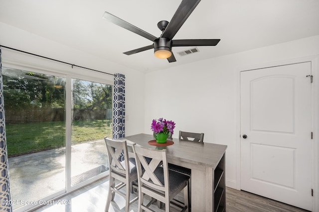 dining space with ceiling fan and hardwood / wood-style floors