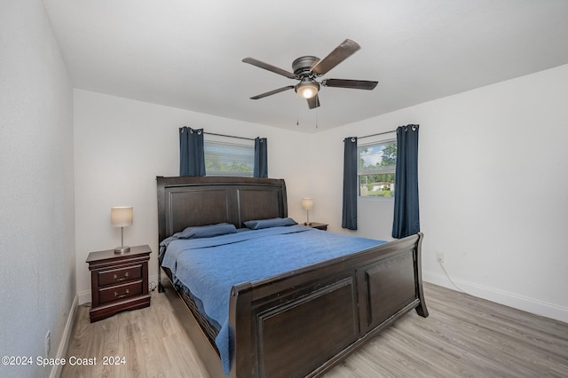 bedroom with ceiling fan and light wood-type flooring