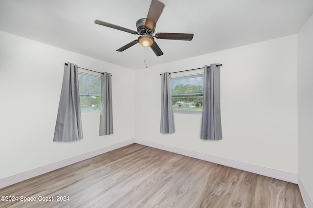 unfurnished room featuring light wood-type flooring and ceiling fan