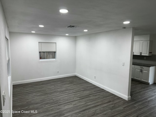 empty room with dark wood-type flooring