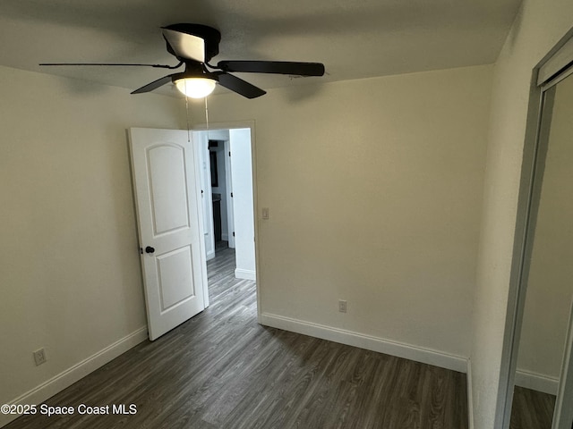 unfurnished bedroom featuring ceiling fan and dark hardwood / wood-style floors