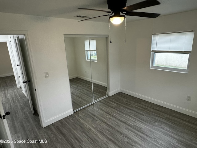 unfurnished bedroom featuring a closet, ceiling fan, and dark hardwood / wood-style floors