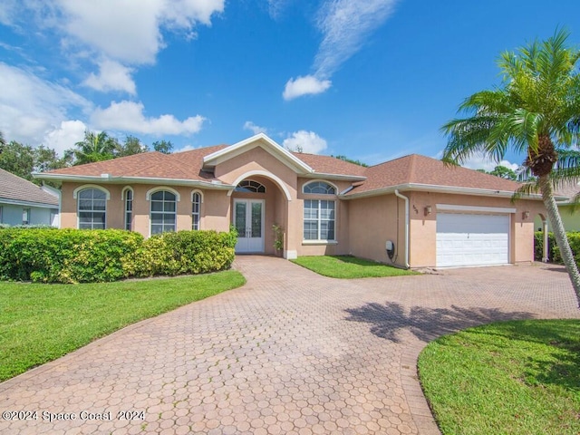 view of front of house featuring a garage and a front lawn