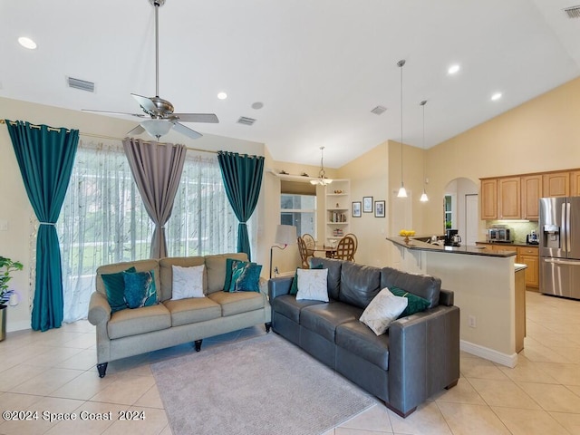 living room with vaulted ceiling, ceiling fan, and light tile patterned flooring