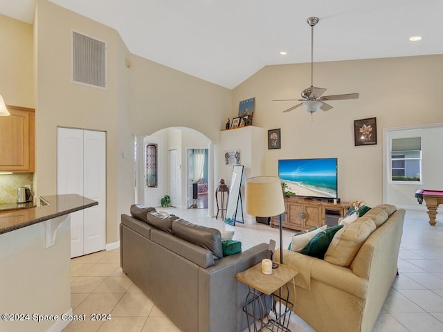 tiled living room featuring ceiling fan, billiards, and high vaulted ceiling